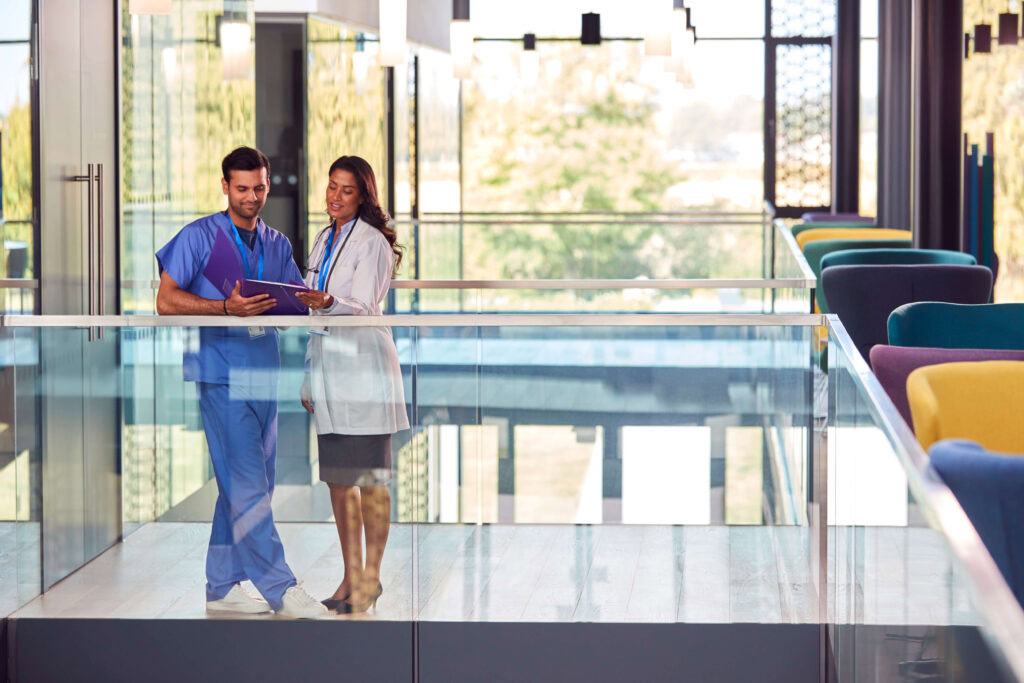 medical staff in white coat and scrubs discussing 2024 10 19 21 34 46 utc