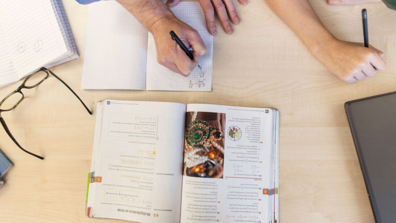 teacher with schoolboy doing homework in classroom 2024 10 18 05 40 18 utc 1920x1080 1