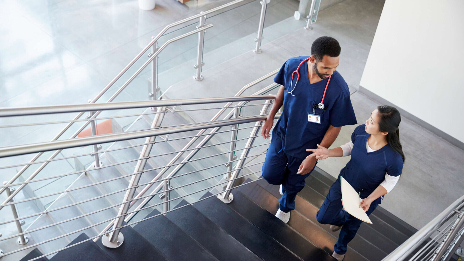 two healthcare colleagues talking on the stairs at 2024 10 19 04 22 57 utc edited